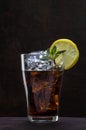 Glass of cola or coke with ice cubes, lemon slice and peppermint Royalty Free Stock Photo
