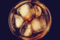 A glass of cola with ice close-up in the dark. Brown carbonated drink, non-alcoholic beverage with caffeine. Top view Royalty Free Stock Photo