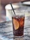 Glass of cola with ice cube, slice of lemon and straw in glass Royalty Free Stock Photo