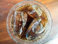 Glass of cola with ice top view.