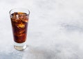 Glass of cola soda drink with ice cubes and bubbles on stone kitchen table background Royalty Free Stock Photo