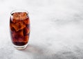 Glass of cola soda drink with ice cubes and bubbles on stone kitchen table background. Royalty Free Stock Photo