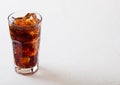 Glass of cola soda drink with ice cubes and bubbles on stone kitchen table background Royalty Free Stock Photo