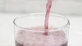 A Glass with Cold, Acidulated, and Refreshing Grapefruit Drink. Filling a Glass with a Fresh and Tasty Drink with Bubbles.