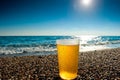 Glass of cold beer on a background of the sea