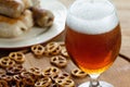 Glass of cold beer. Traditional pretzels german Oktoberfest snacks, sausage.