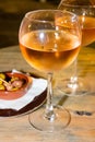 A glass of cold chilled rose wine served at a restaurant table. Water droplets are dripping Royalty Free Stock Photo