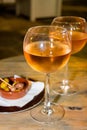 A glass of cold chilled rose wine served at a restaurant table. Water droplets are dripping Royalty Free Stock Photo