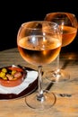 A glass of cold chilled rose wine served at a restaurant table. Water droplets are dripping Royalty Free Stock Photo