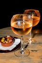 A glass of cold chilled rose wine served at a restaurant table. Water droplets are dripping Royalty Free Stock Photo