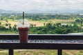 Glass of cold coffee on table iron table