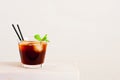 Glass of cold coffee or tea with ice cubes on the white table Royalty Free Stock Photo