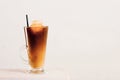 Glass of cold coffee or tea with milk and ice cubes on the white Royalty Free Stock Photo