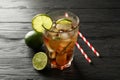 Glass of cold cola with citrus and ice on wooden table Royalty Free Stock Photo