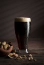 Dark beer and peanuts Royalty Free Stock Photo