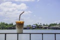 Glass of cold espresso coffee on the iron balcony Background views of the river and the home