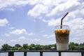 Glass of cold espresso coffee on the iron balcony Background views of the river and the home