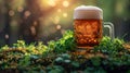 Glass with cold fresh golden beer on wooden table on green blurred background with lights. Oktoberfest and St. Patrick\'s day Royalty Free Stock Photo
