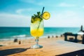 Glass of cold fresh summer cocktail on wooden table with ocean view on background Royalty Free Stock Photo