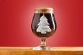 Glass of cold frothy dark beer on an old wooden table Royalty Free Stock Photo