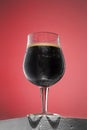 Glass of cold frothy dark beer on an old wooden table Royalty Free Stock Photo