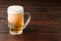 Glass of cold frothy lager beer on old wooden table Royalty Free Stock Photo