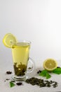 Glass of cold green tea with lemon on a white background Royalty Free Stock Photo