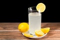 A glass of cold lemonade with a piece of yellow lemon Royalty Free Stock Photo