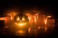 Glass of cold light beer with pumpkin on a wood background for Halloween. Glass of fresh beer and pumpkin on a dark toned foggy ba Royalty Free Stock Photo