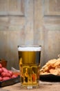 Glass of cold light beer with snacks Royalty Free Stock Photo