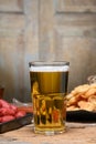 Glass of cold light beer with snacks Royalty Free Stock Photo