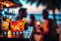 Glasses of cocktails on the table of a beach bar. Sunset, blurry people. Summer holidays travel. Generative AI. Royalty Free Stock Photo