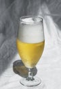 Glass with cold refreshing beer on a white background, in the art style. The concept of relaxation, bars and parties Royalty Free Stock Photo