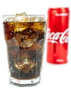 Glass of cold refreshing coca cola soda with ice, metal can of coca cola classic, isolated on white Royalty Free Stock Photo