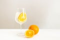 A glass of cold still water with orange slice and ice on light background. Healthy lifestyle and a good start of the day Royalty Free Stock Photo