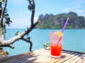 Glass of cold strawberry soda juice  on bamboo table over blue sea background Royalty Free Stock Photo