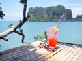 Glass of cold strawberry soda juice  on bamboo table over blue sea background Royalty Free Stock Photo