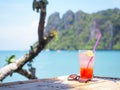 Glass of cold strawberry soda juice  on bamboo table over blue sea background Royalty Free Stock Photo