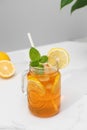 A glass of cold tea, ice cubes, lemon slices and a sprig of mint. Cooling summer drinks. Royalty Free Stock Photo