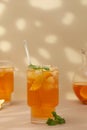 A glass of cold tea, ice cubes, lemon slices and a sprig of mint. Cooling summer drinks. Royalty Free Stock Photo