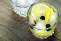 Glass of cold water with ice and lemon on a wooden table. close up. Royalty Free Stock Photo