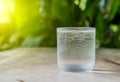 Glass cold water on wooden floor.