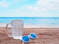 glass of cold water on wooden table over summer beach background Royalty Free Stock Photo