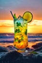 Glass of colorful summer cocktail on the beach at sunset with blurred beach background. Tropical cocktail with ice cubes, lime