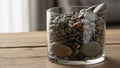 Glass container filled with assorted smooth pebbles of various Royalty Free Stock Photo