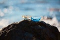 Glass containers with candles on sharp rock. Romantic spa time and nature. Beauty treatment and relaxation concept