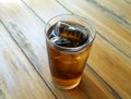 1 glass cool cola on wood table.