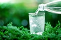 A glass of cool fresh water on natural green background Royalty Free Stock Photo