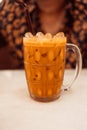 A glass cool of Thai milk tea in vintage glass