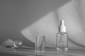 Glass cosmetic bottle, serum with peptides and retinol product packaging and modern acrylic transparent geometric shapes